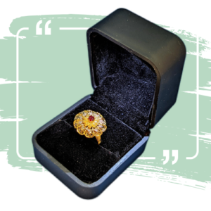 Intricate Gold-Plated Ring with Red Stone Centerpiece